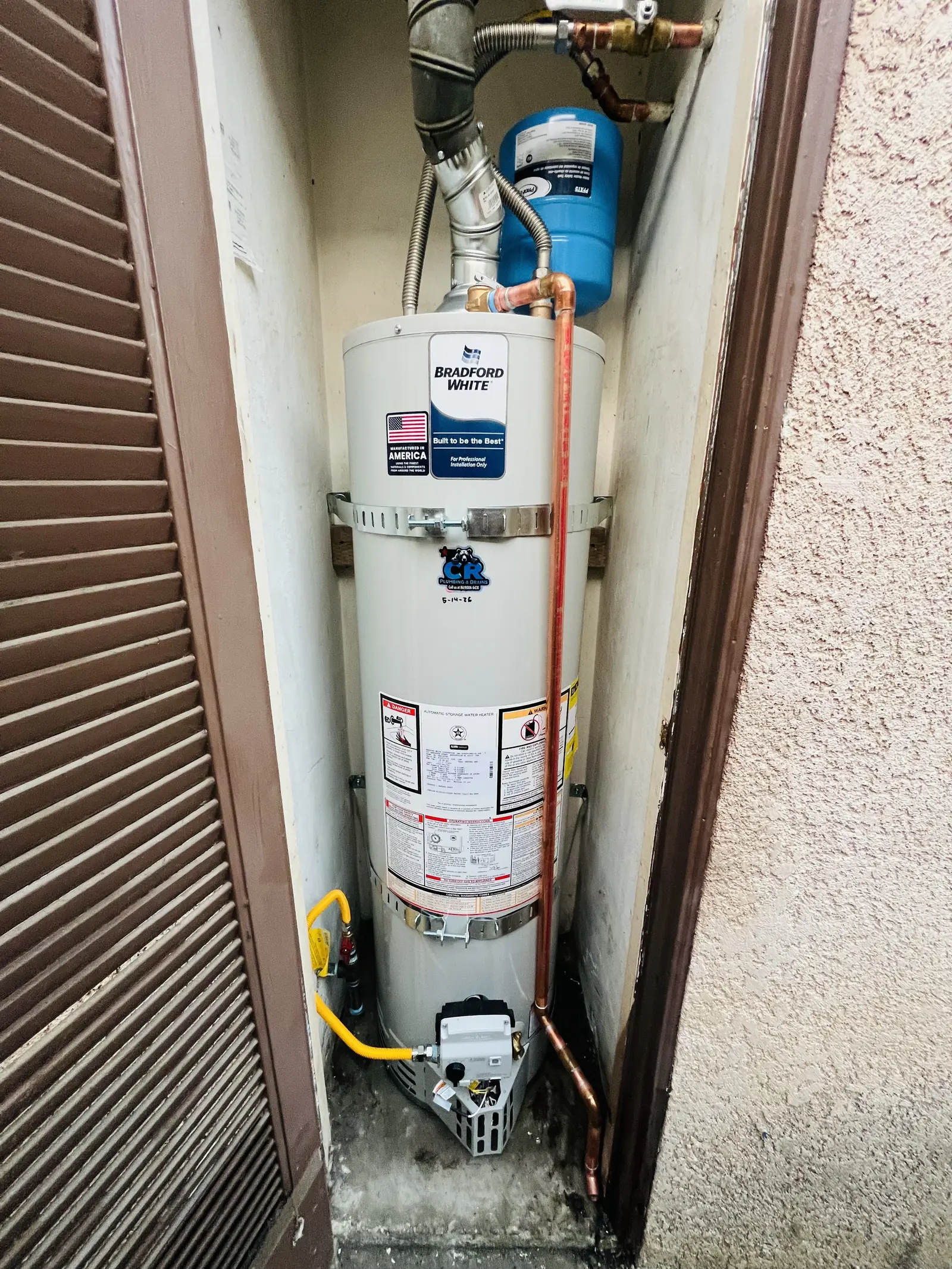 A Bradford White water heater in a louvered closet with new copper lines